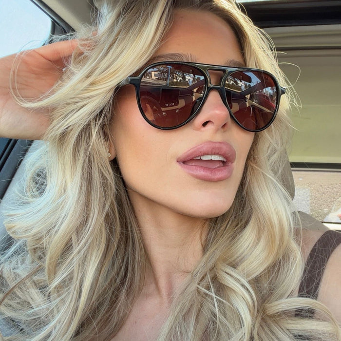 shelby hunstad blonde influencer in car wearing tosca ii aviators