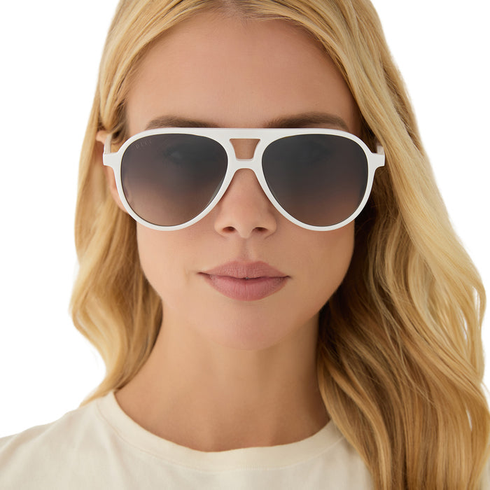 on model - blonde female wearing diff eyewear featuring the tosca ii aviator sunglasses with a snowbound frame and grey gradient with silver flash lenses front view