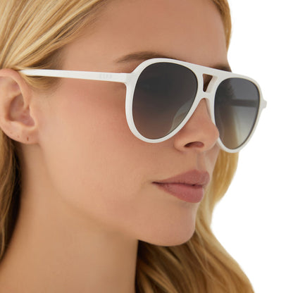 on model - blonde female wearing diff eyewear featuring the tosca ii aviator sunglasses with a snowbound frame and grey gradient with silver flash lenses side view