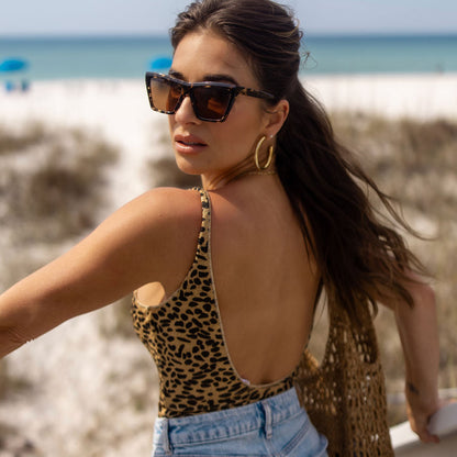 lifestyle - jessie james decker x diff eyewear featuring the vivi cat eye sunglasses with a espresso tortoise frame and brown lenses angled view