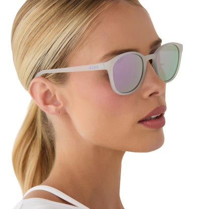 on model - female wearing diff sport featuring the volley round sunglasses with a frosty matte crystal frame and lavender mirror polarized lenses side view
