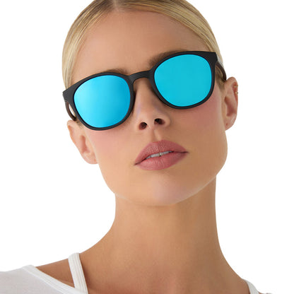 on model - female wearing diff sport featuring the volley round sunglasses with a matte black frame and blue mirror polarized lenses front view