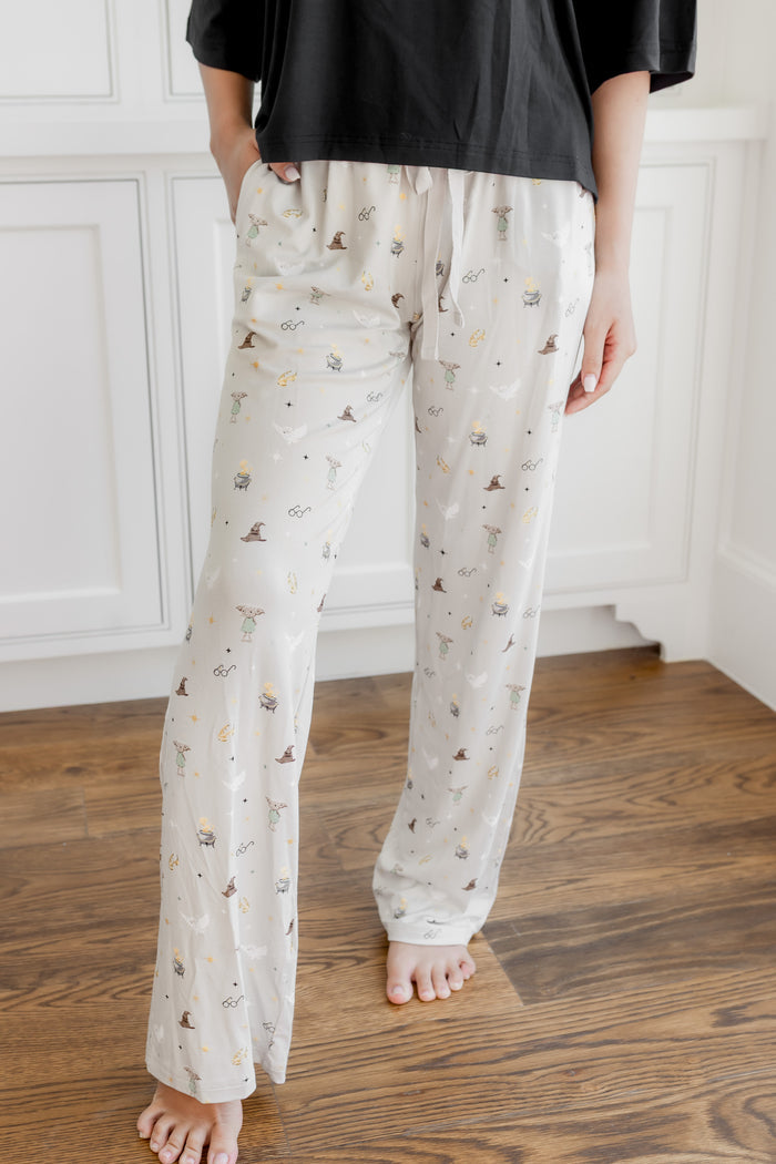 Model wearing a cream Harry Potter patterned lounge pant with pockets under a black tee shirt