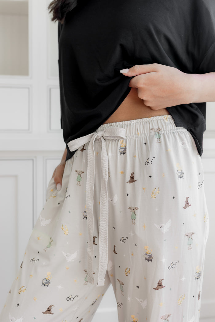 Women's cream lounge pant with Harry Potter pattern on it with drawstring.