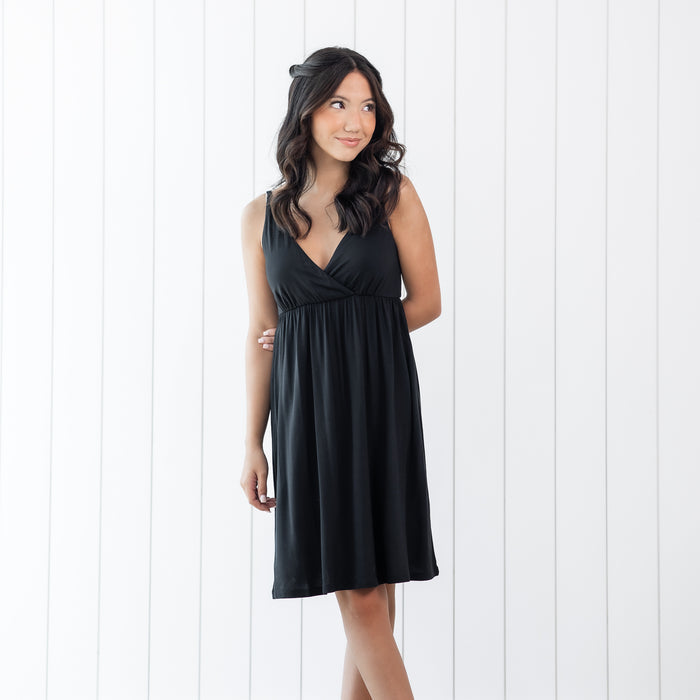 Woman wearing a black nightgown against a white background