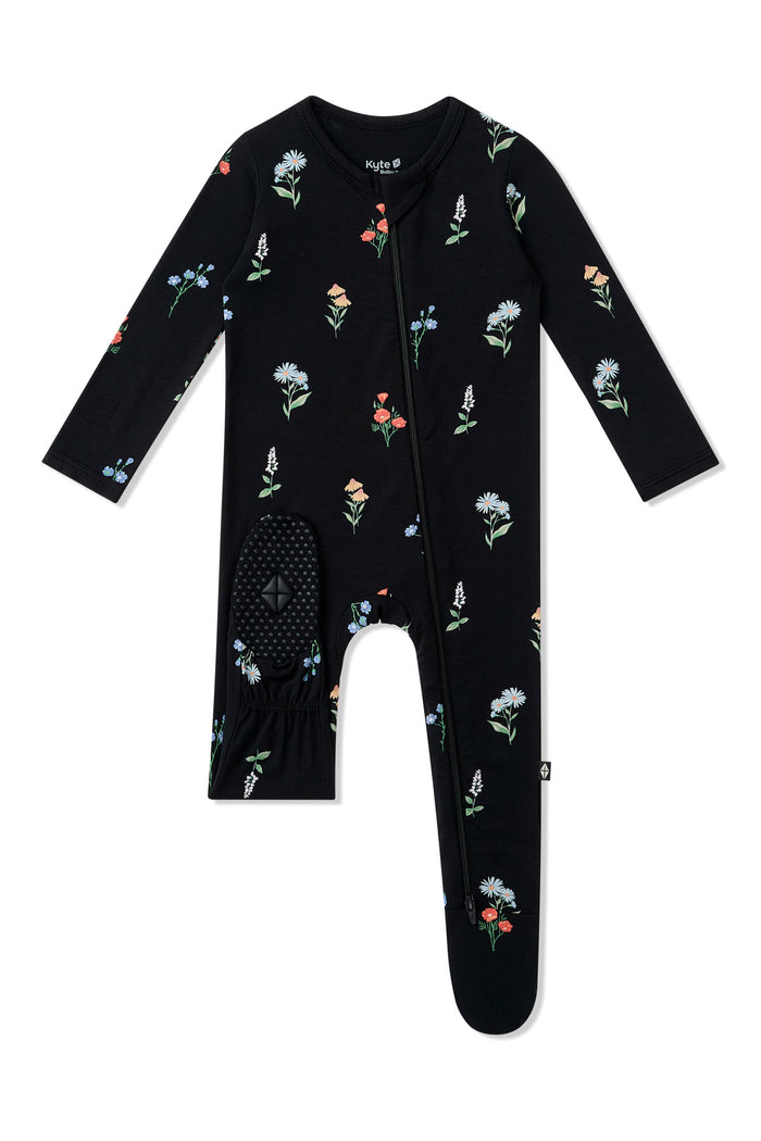 Dotted footie on Black Zippered Footie in Wildflower print on a white background