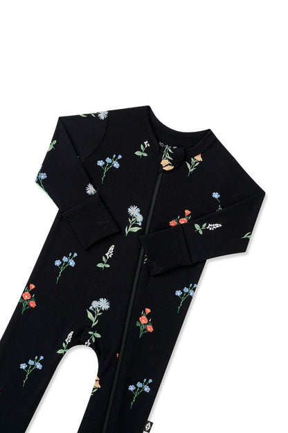 Black Zippered Romper in Wildflower print with zipper on a white background