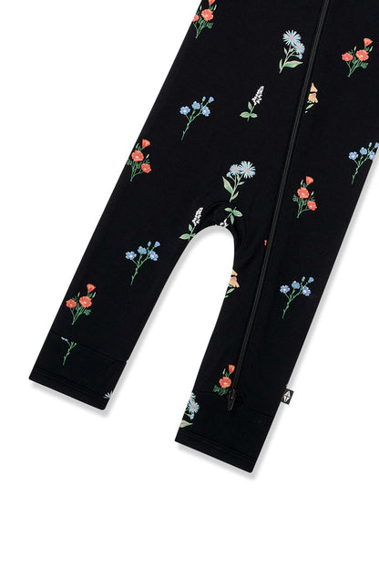 Bottom part of Black Zippered Romper in Wildflower print on a white background